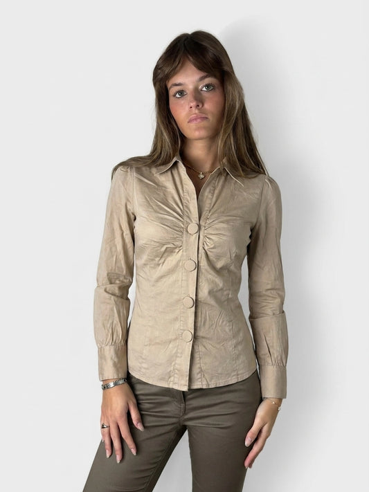 Beige button-up blouse with ruched bust, displayed in front view.