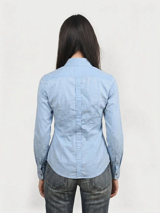 Back view of a sky blue button-up shirt featuring a clean collar and tailored fit.