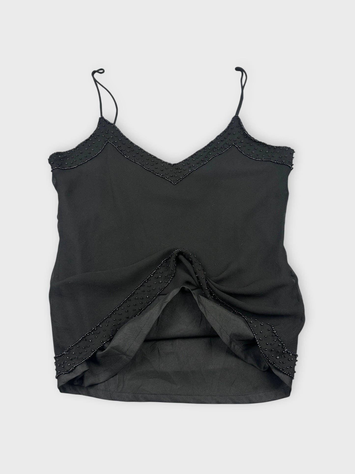 Back view of a black silk camisole featuring lace trim and detailing.