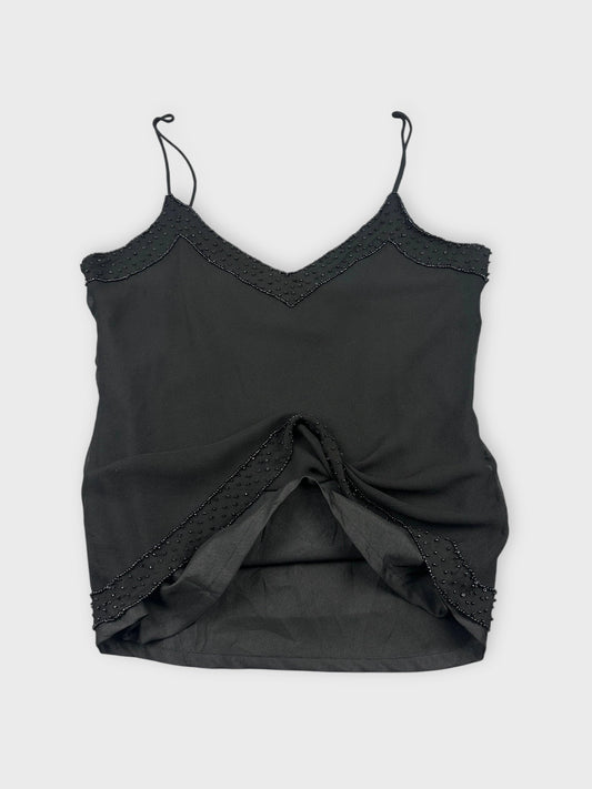 Back view of a black silk camisole featuring lace trim and detailing.