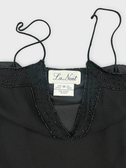 Front view of a black silk camisole featuring lace and bead detailing.