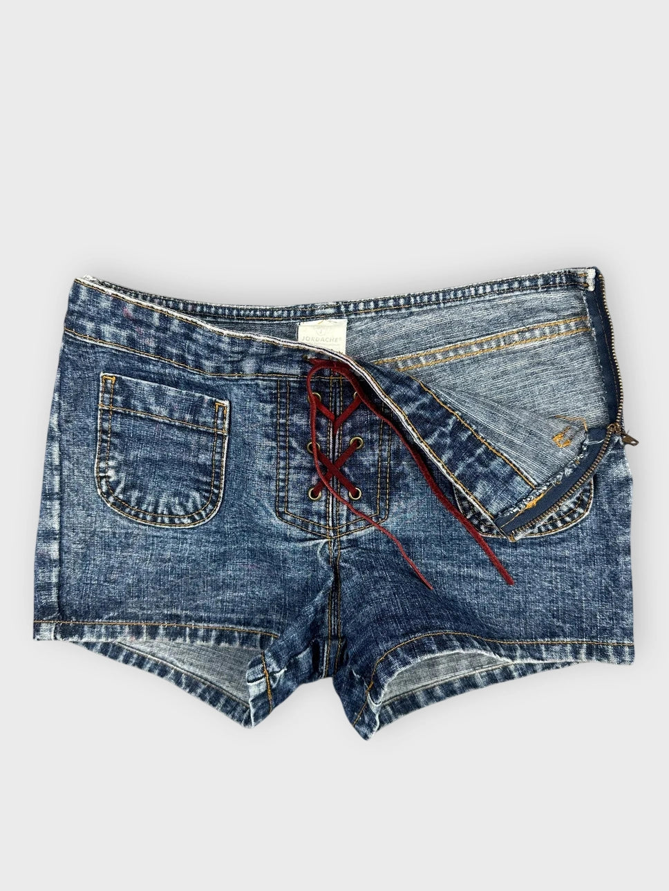 Detail view of blue denim shorts featuring a lace-up front.