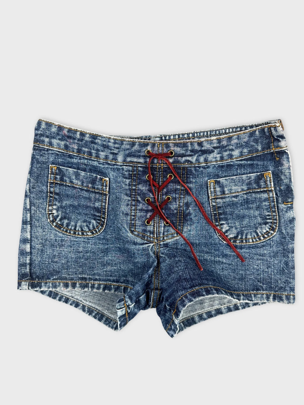 Front view of denim shorts in blue with lace-up detail.
