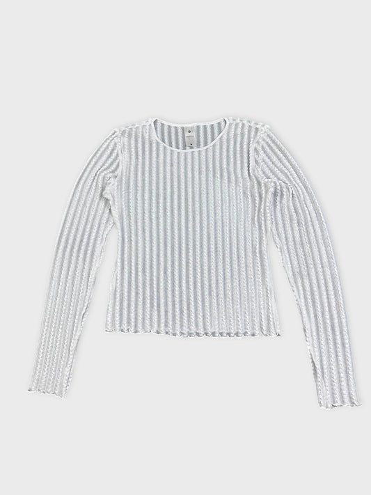 Front view of a white ribbed knit shirt with long sleeves.