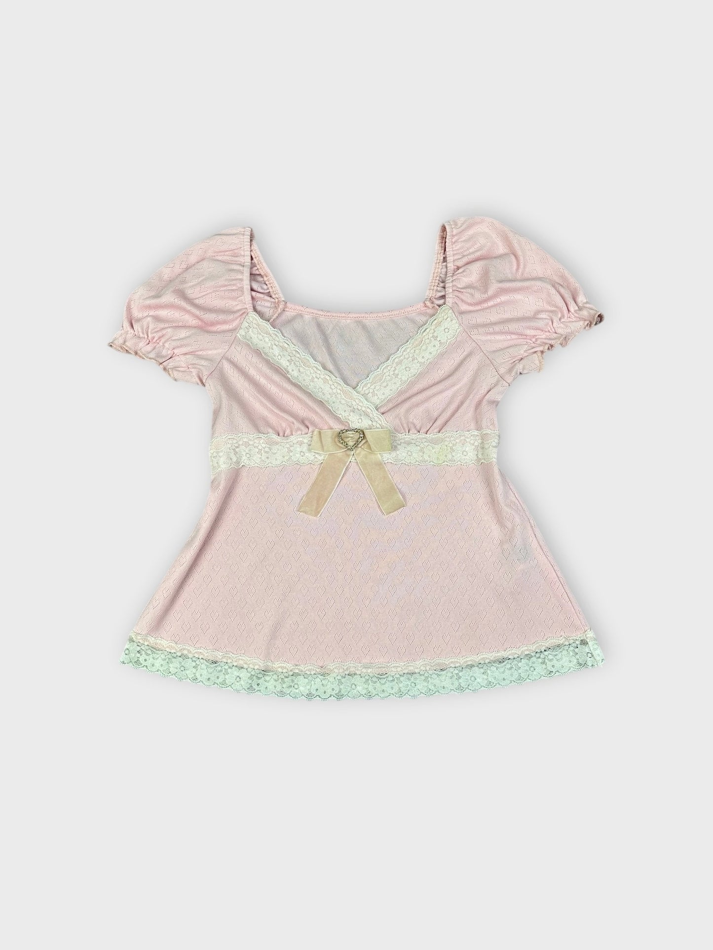 Soft pink lace-trim blouse with bow front view showing lace details and puff sleeves.