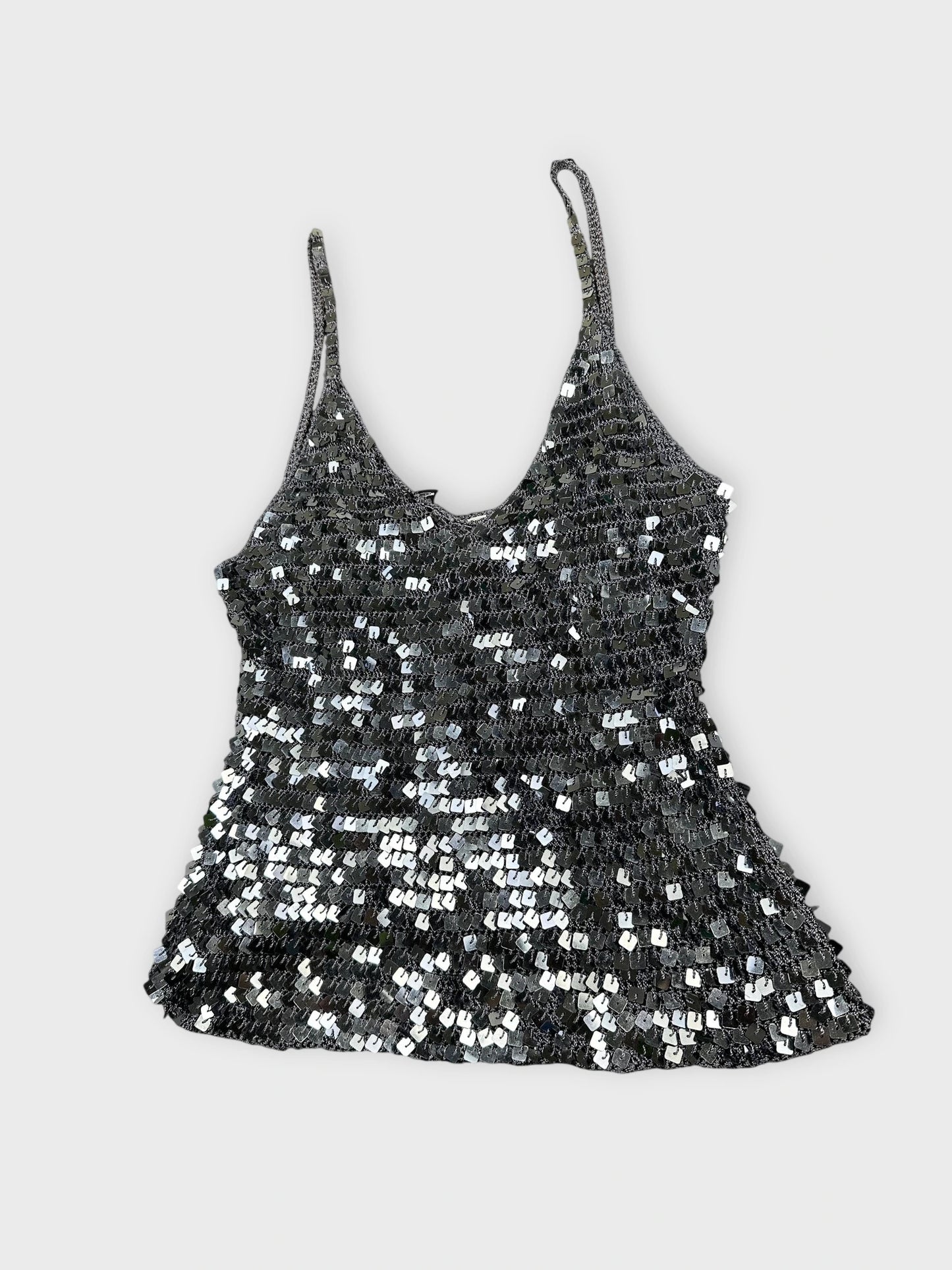 Sparkly silver crop top detail view featuring sequin embellishments and thin straps.