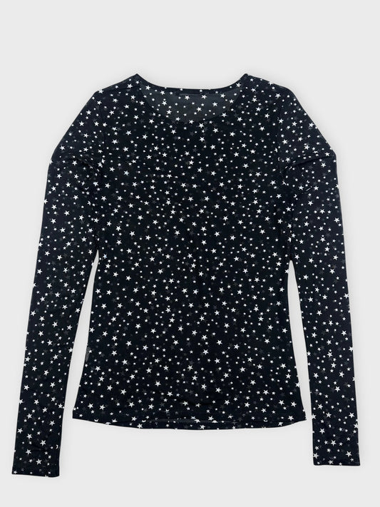 Back view of black long sleeve top featuring a star pattern.