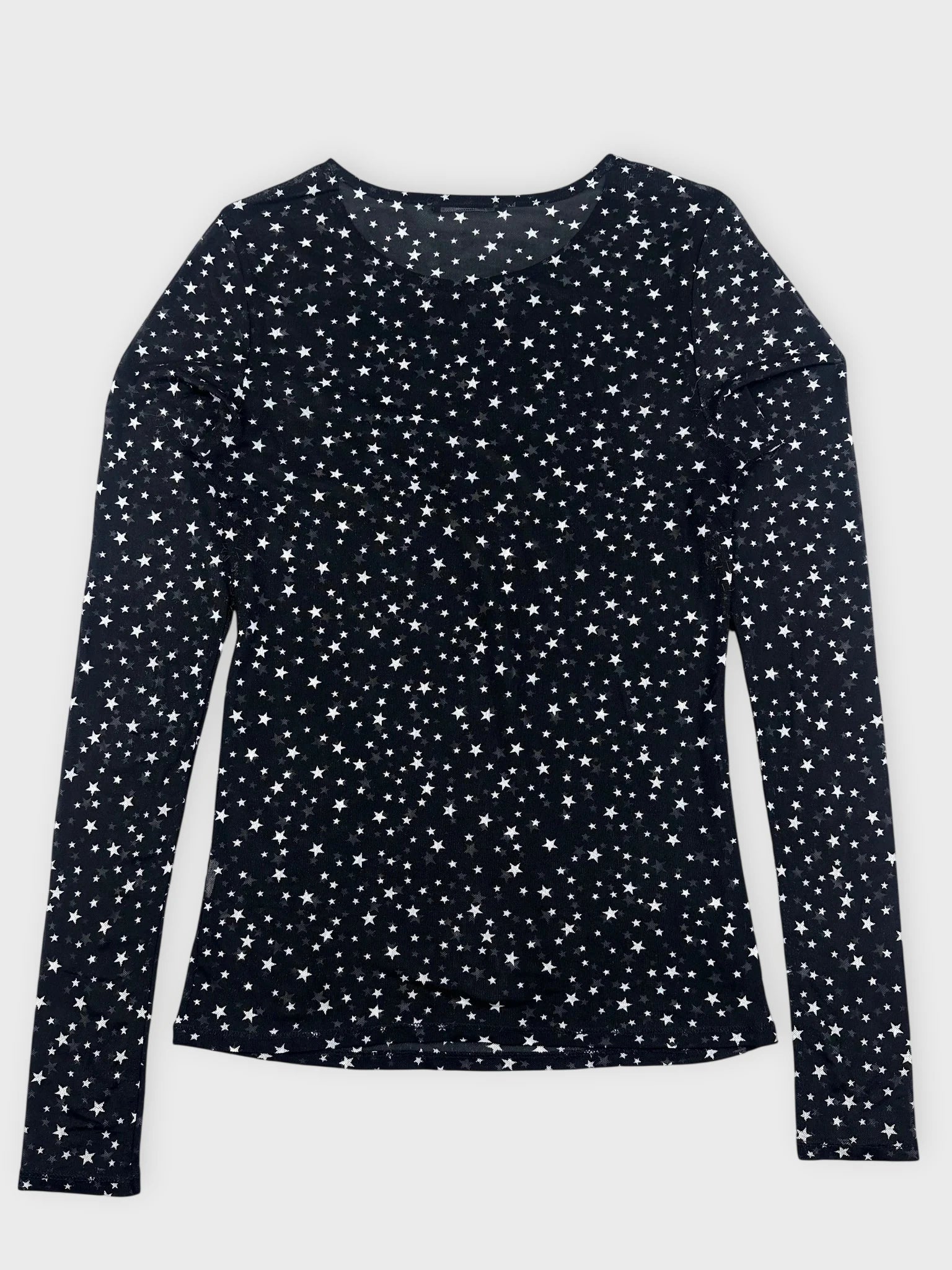 Front view of a long sleeve black top with a star pattern.