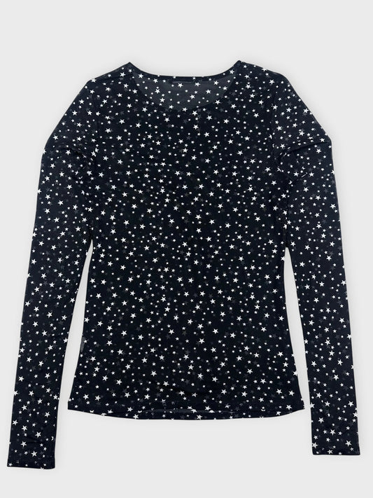 Front view of a long sleeve black top with a star pattern.