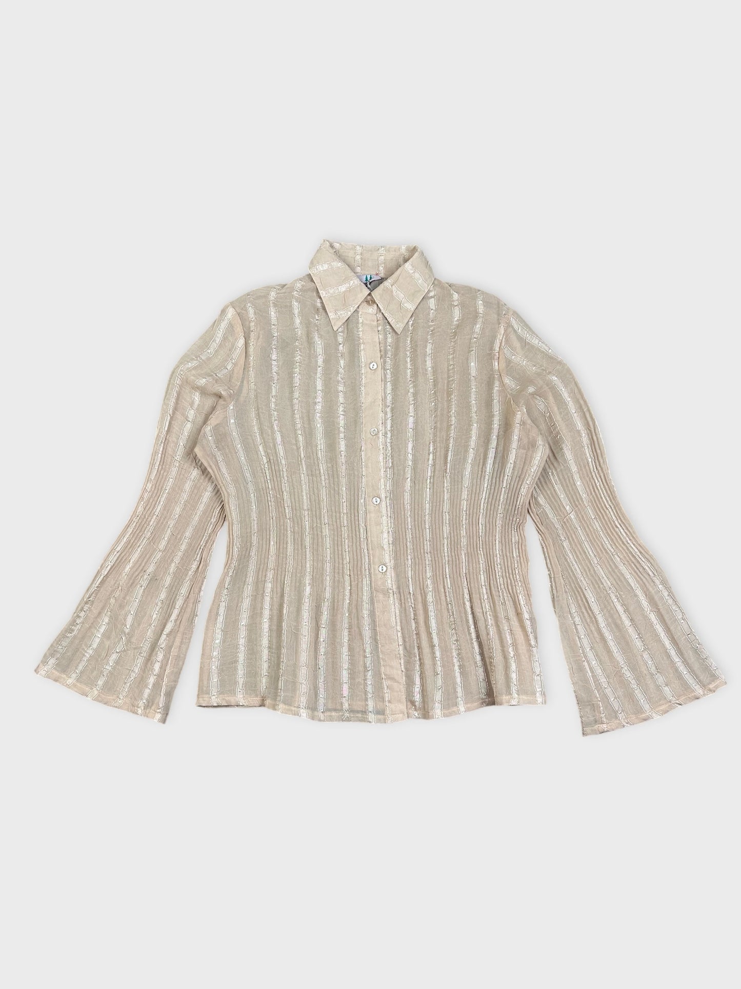 Detail view of a striped blouse in beige with flared sleeves.