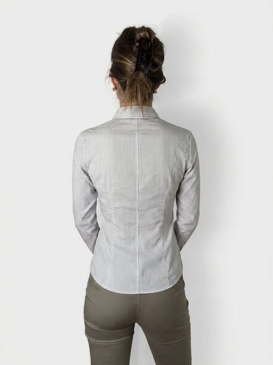 Back view of a striped button-up blouse with ruffle detail.