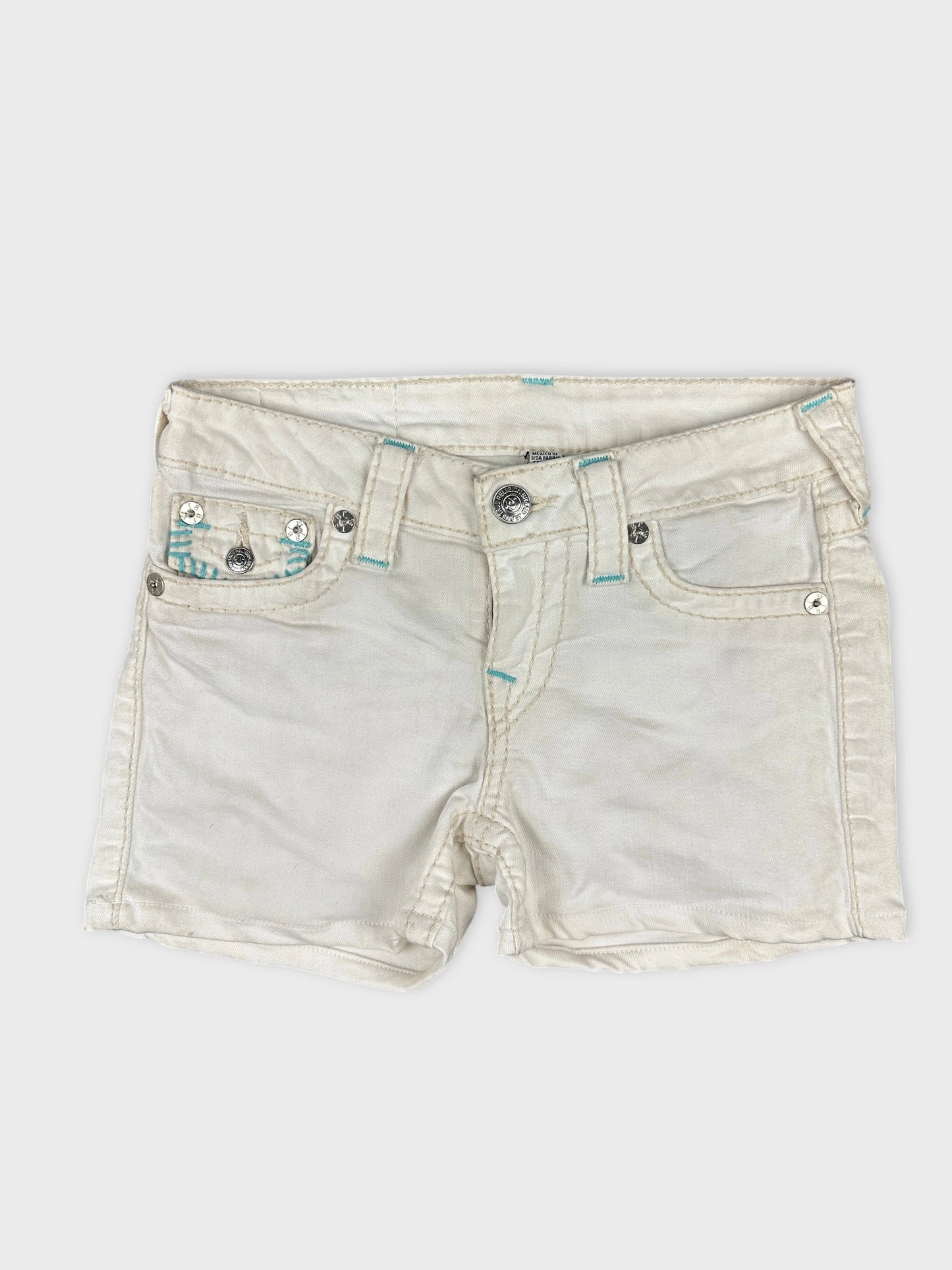Front view of white denim shorts featuring detailed pocket design.