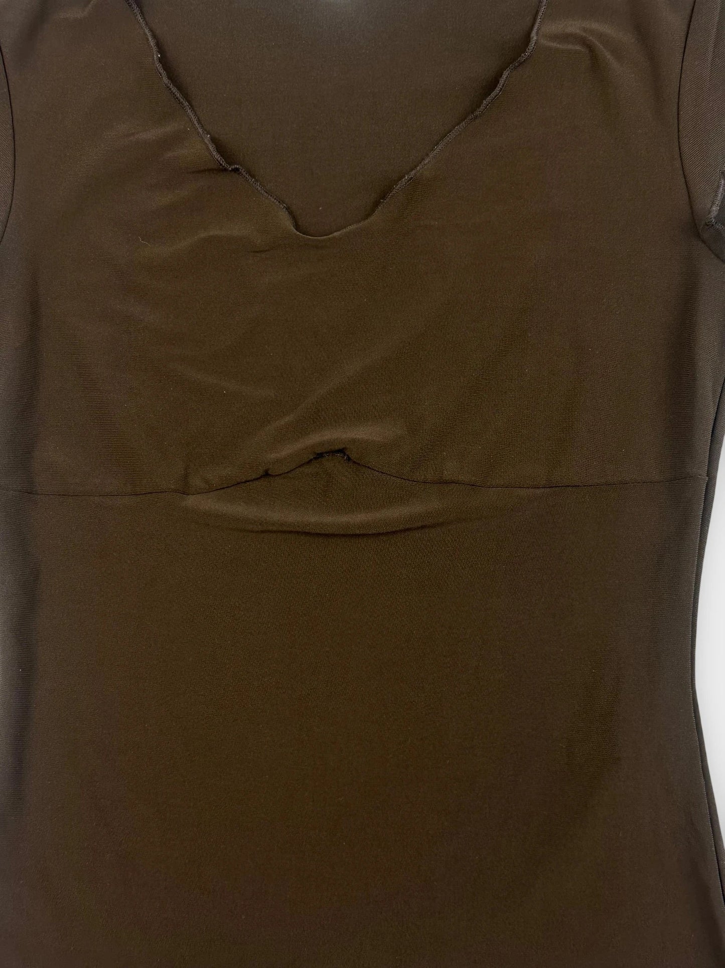 Detail view of a brown crop top with a v-neckline.