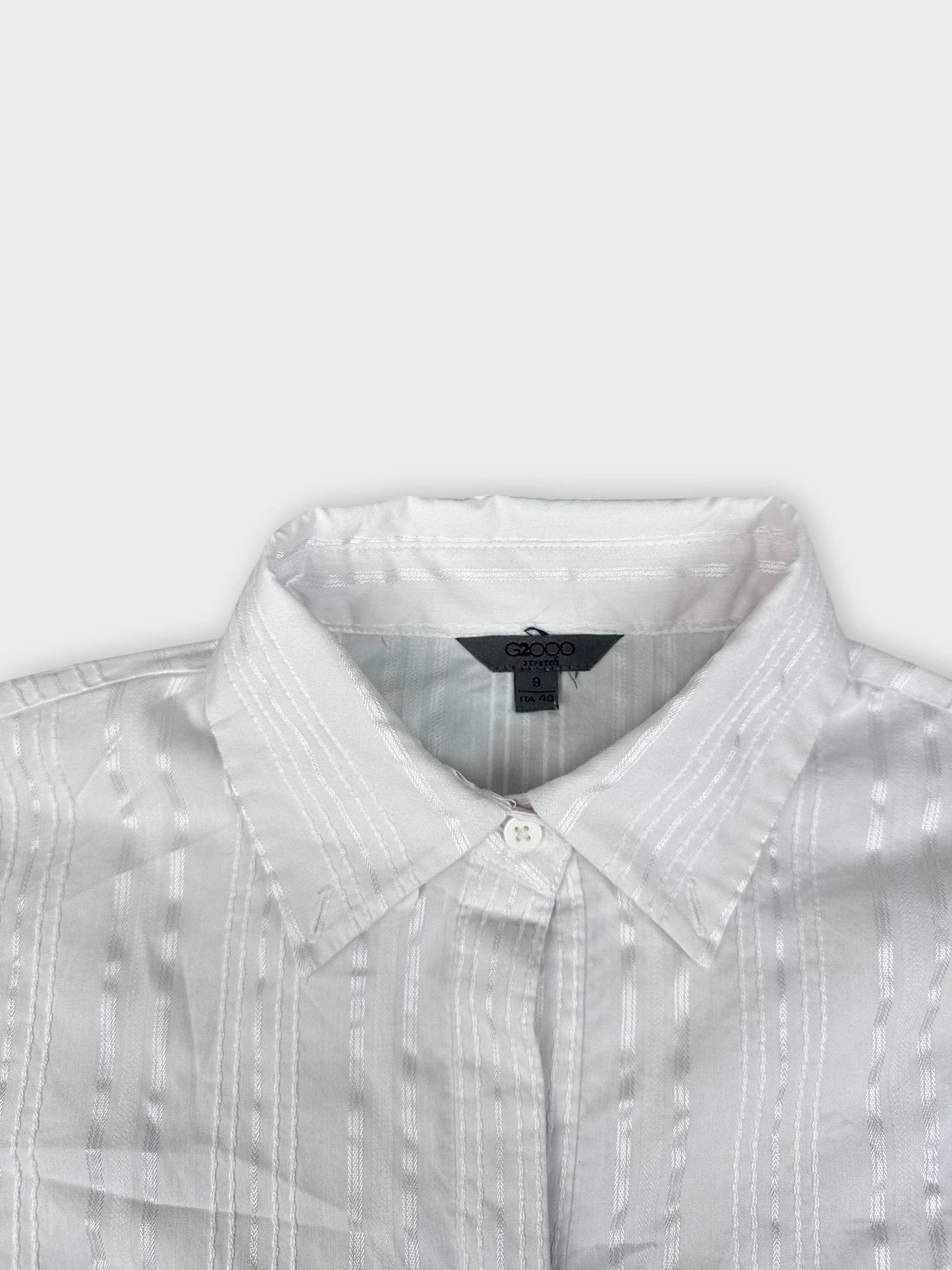 Textured white button-up shirt with subtle stripes detail view