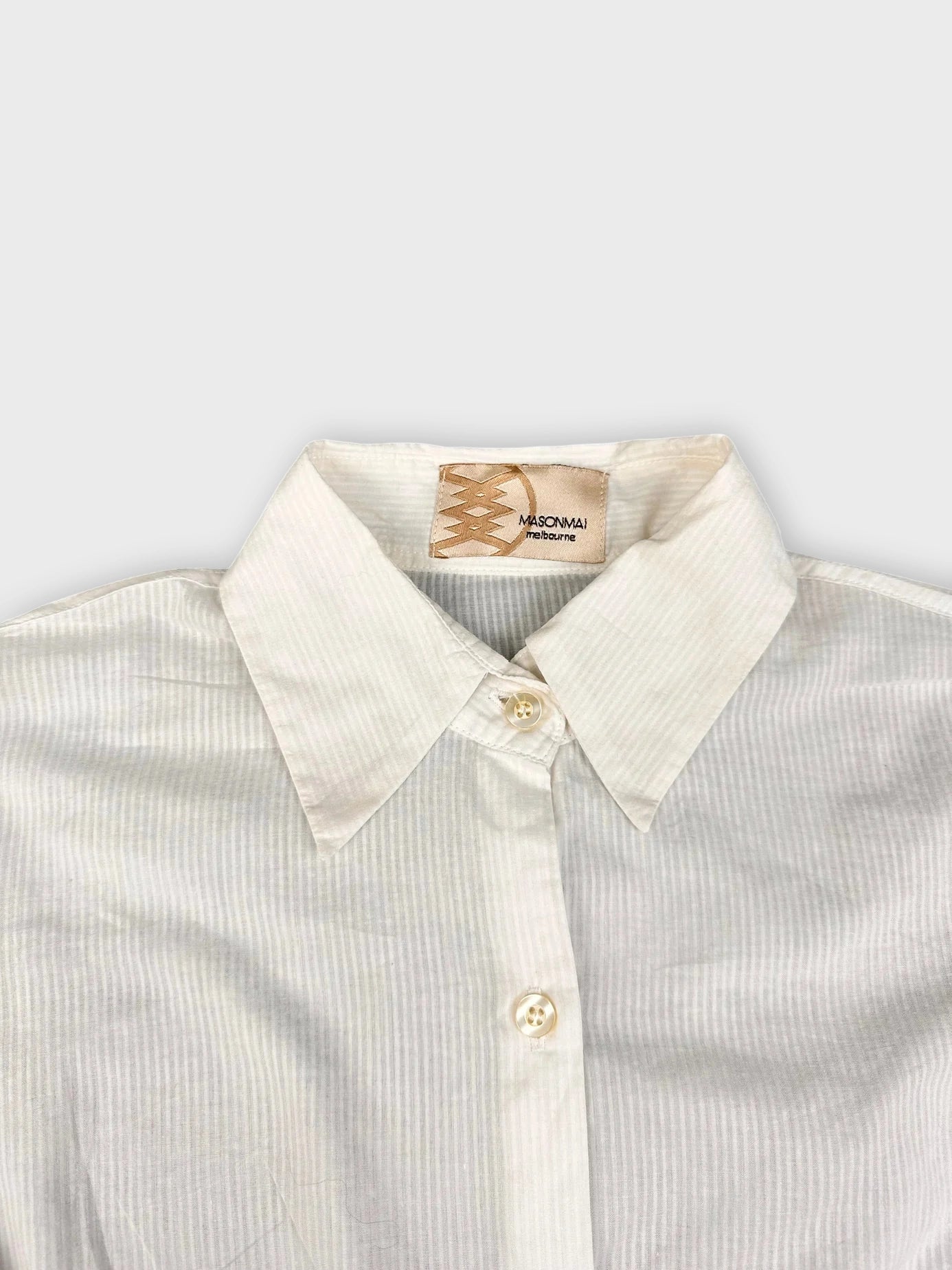 Back view of a white cotton button-up shirt with a striped pattern.
