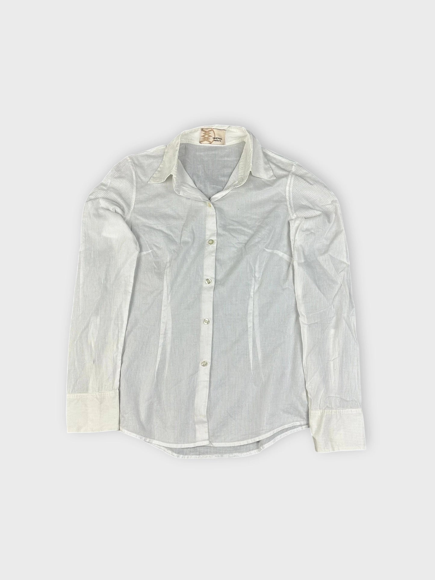 Detail view of white button-up shirt featuring vertical stripes and classic collar.
