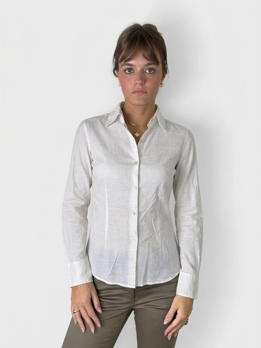White cotton button-up shirt with button detail, front view.