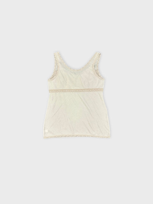 Back view of a white tank top with lace trim detailing.