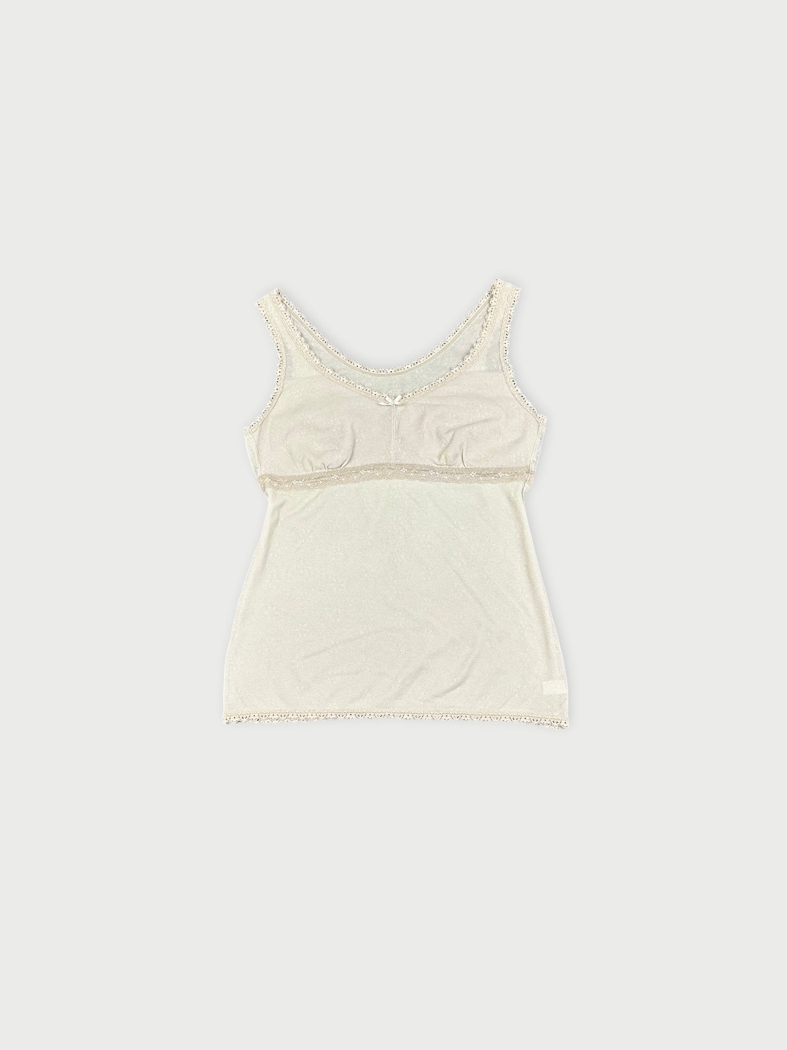 Front view of a white lace-trimmed tank top displaying delicate lace details.
