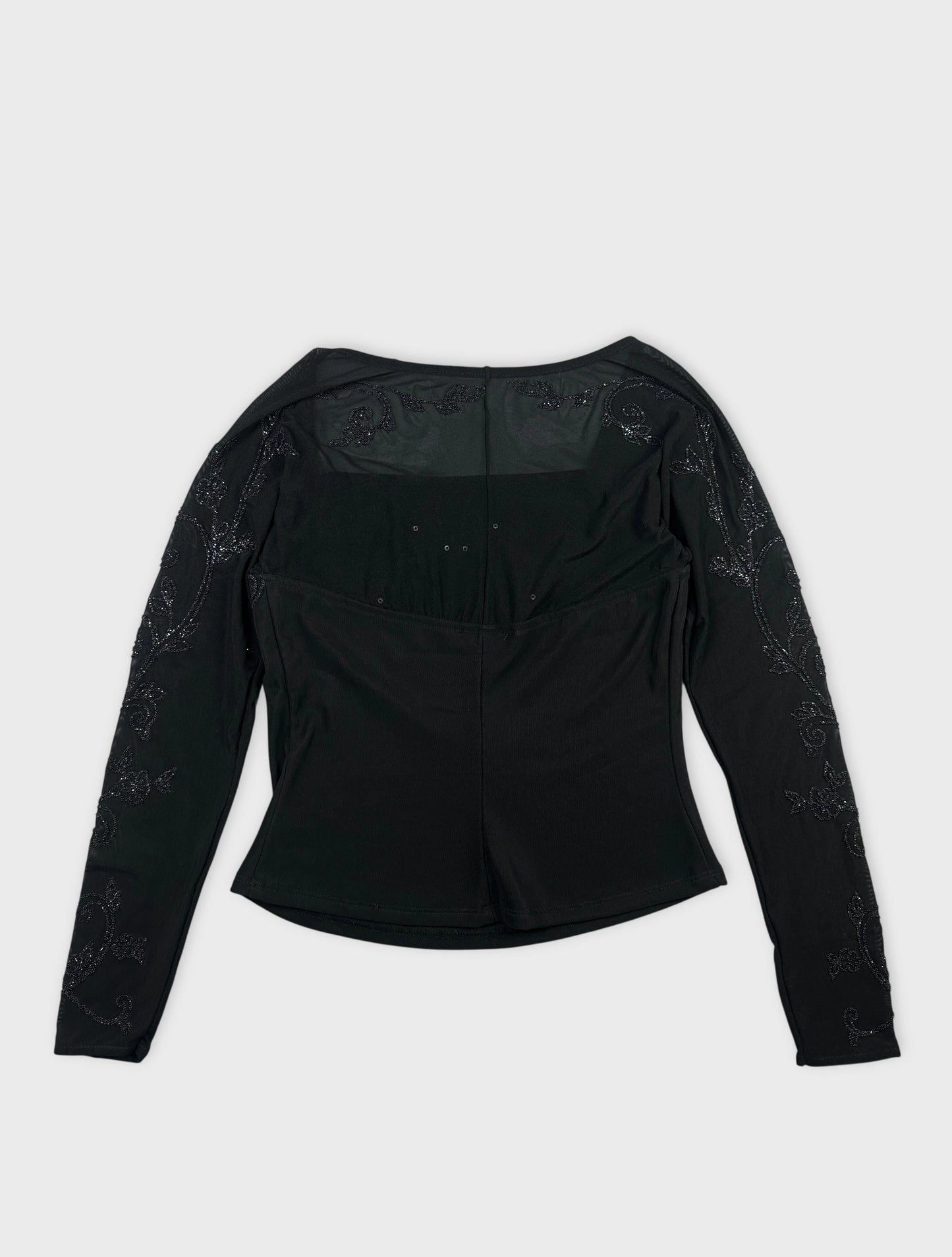 Back view of a black body shirt with floral embroidery on sleeves.