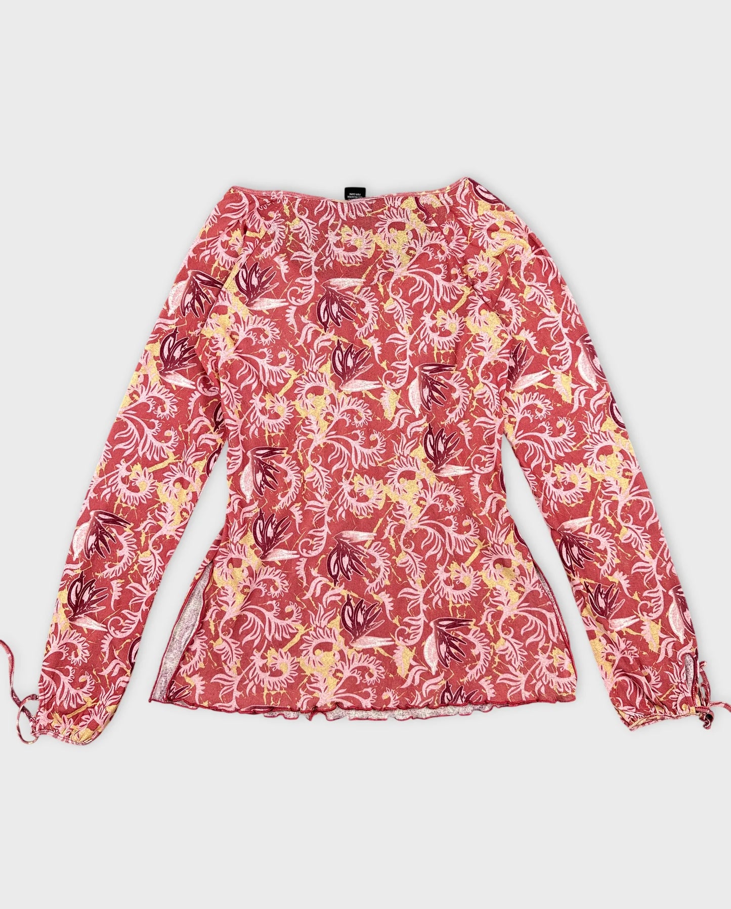 Back view of a women body shirt in red floral pattern.