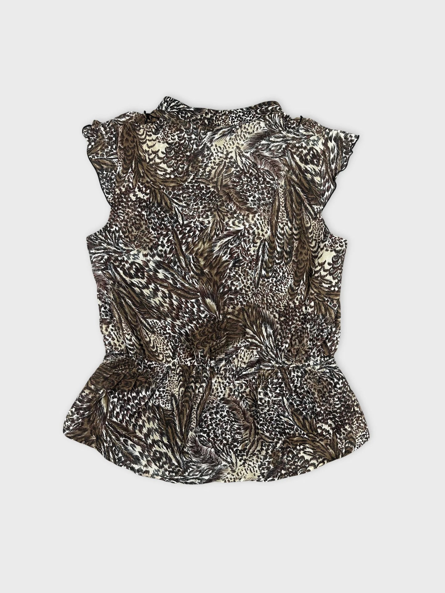 Back view of a brown and cream floral print body shirt with ruffled sleeves.
