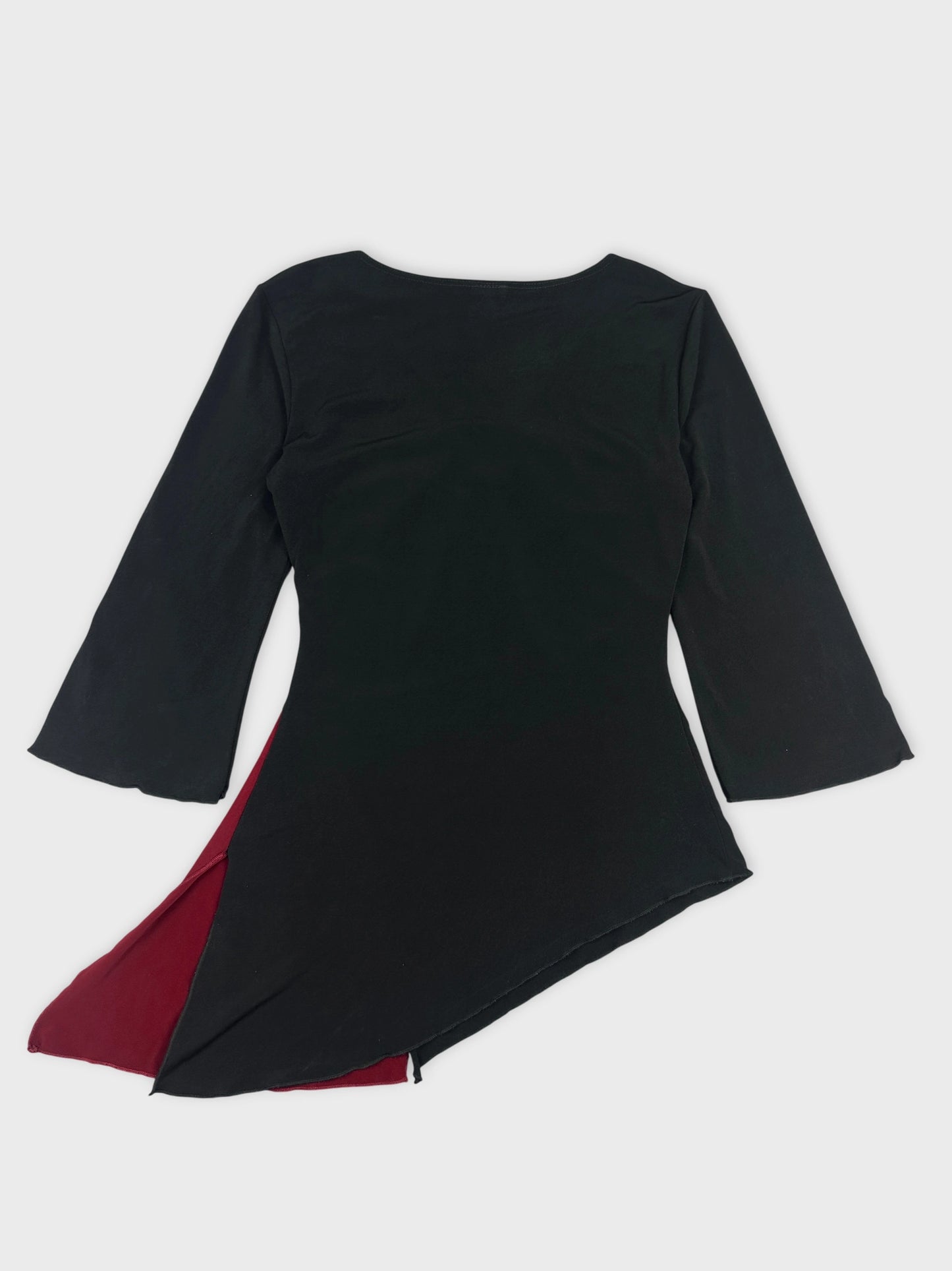 Back view of a black body shirt with a red side detail.