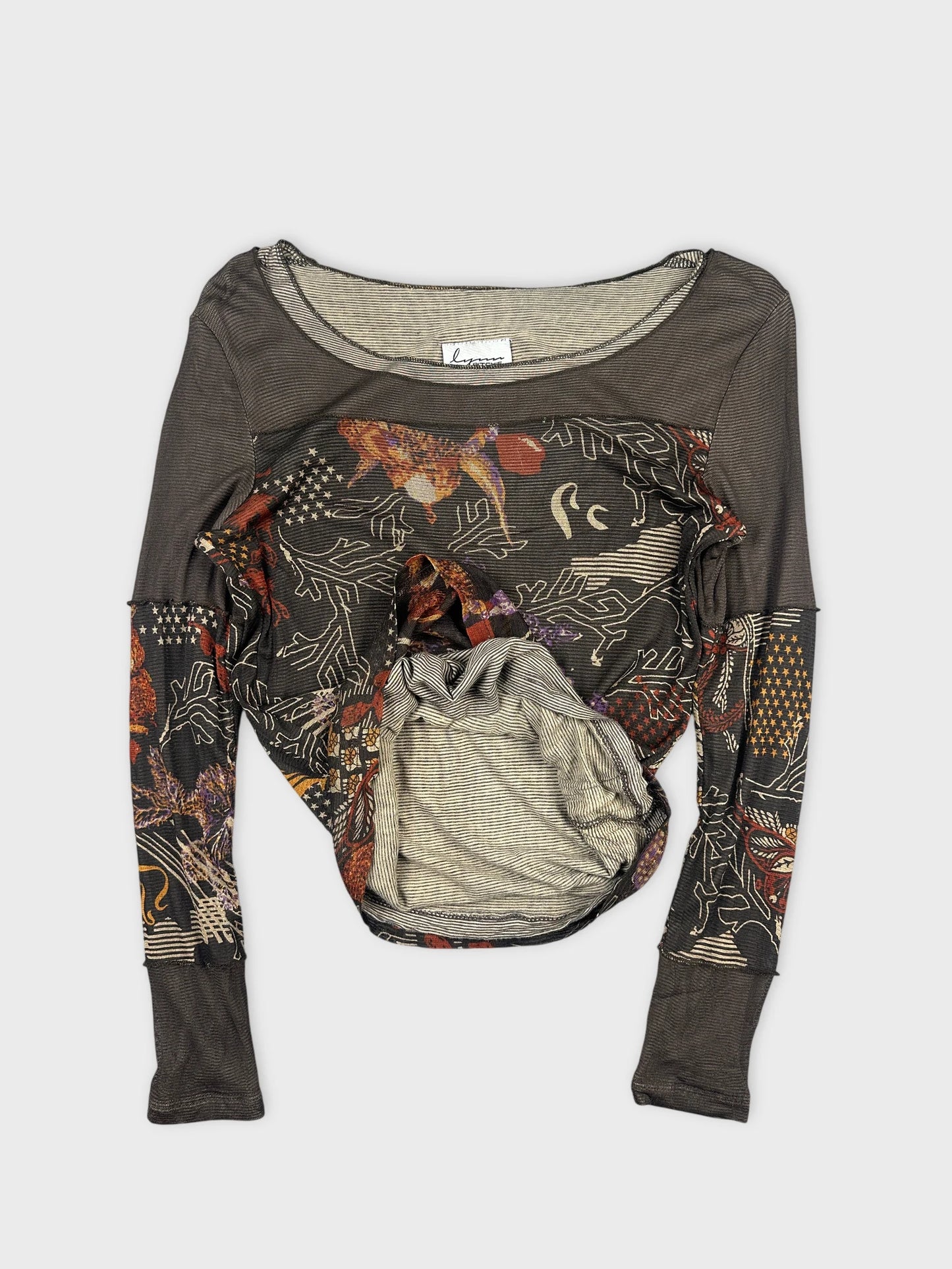 Detail view of a women body shirt in dark gray with colorful printed pattern.