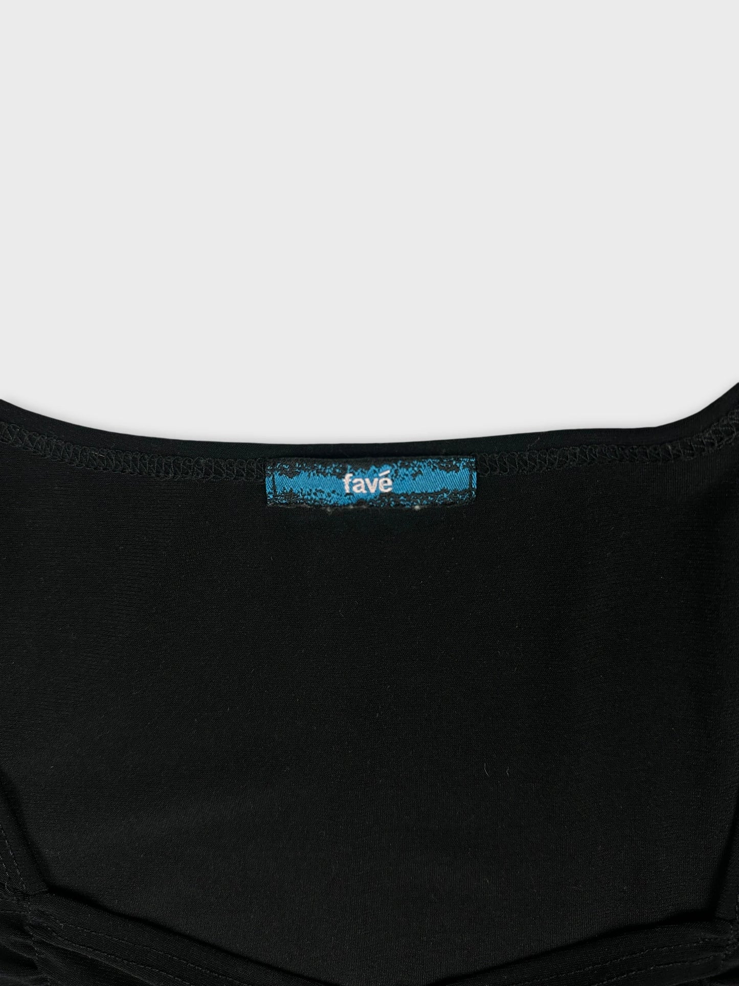 Detail view of a black body shirt featuring a blue label.