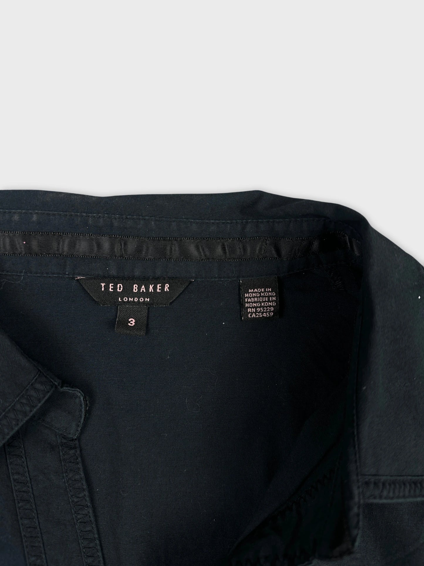 Detail view of a black body shirt featuring ribbed texture.