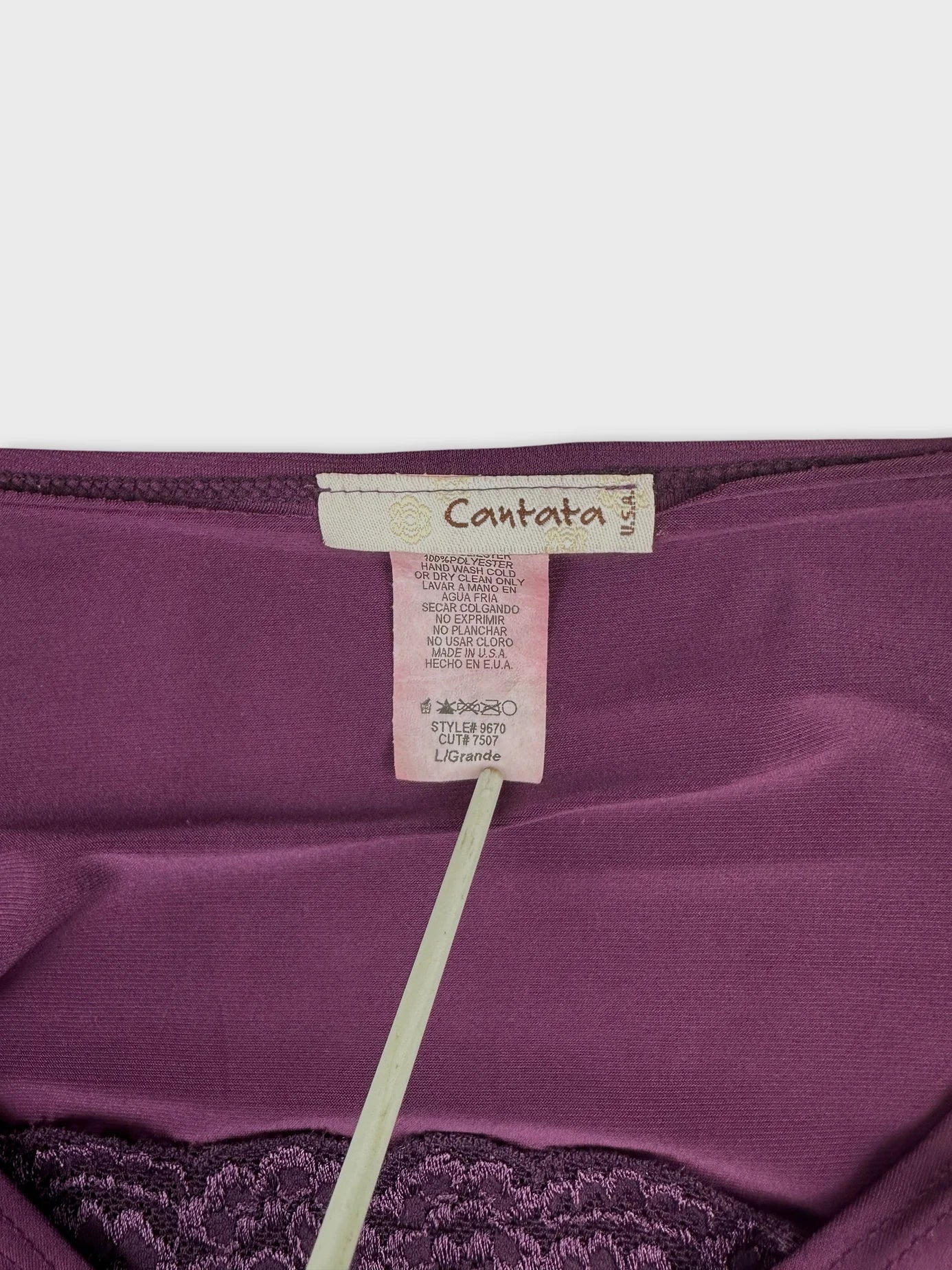 Detail view of a purple body shirt with lace texture