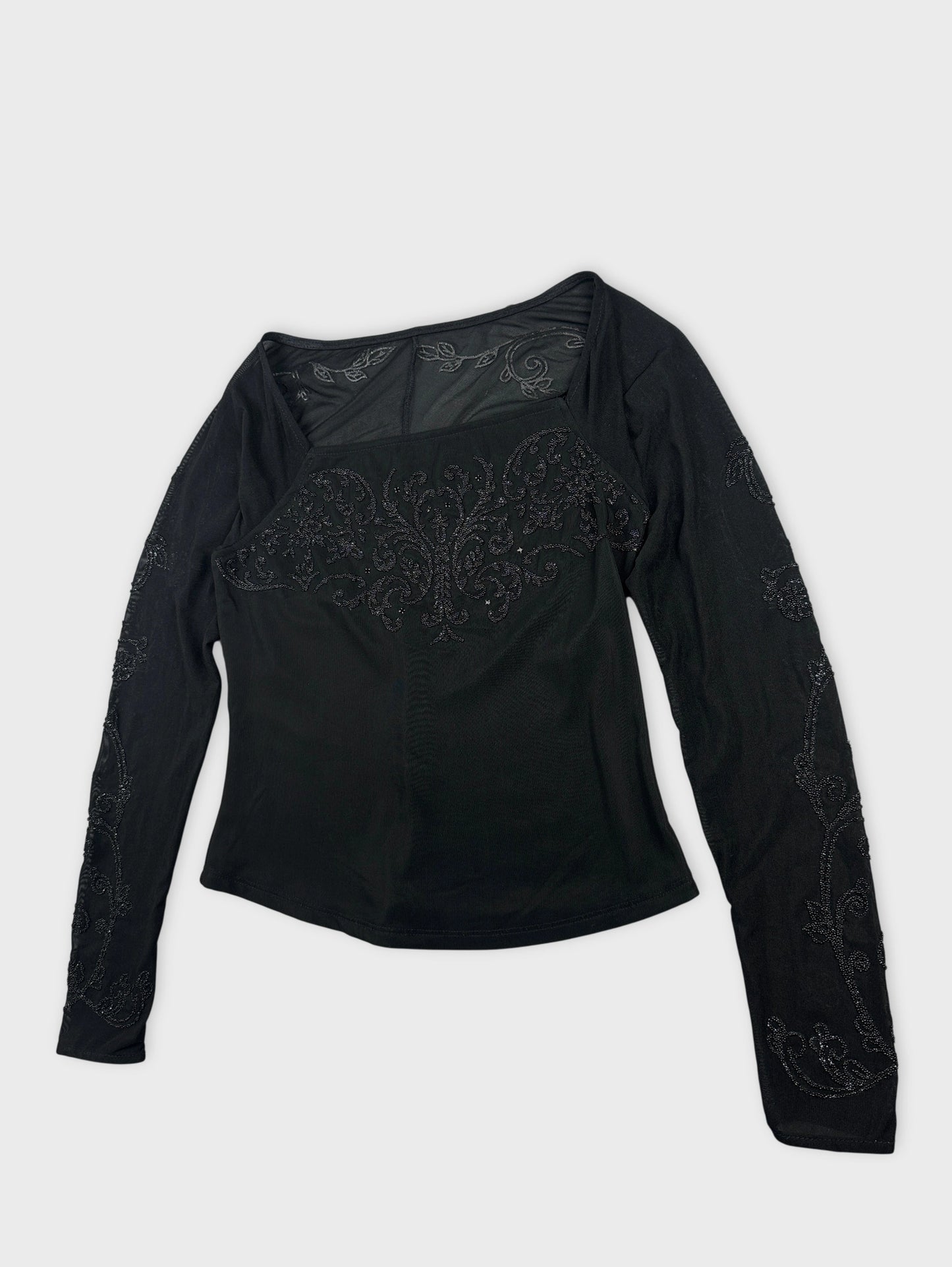 Black body shirt with embroidered detailing detail view.