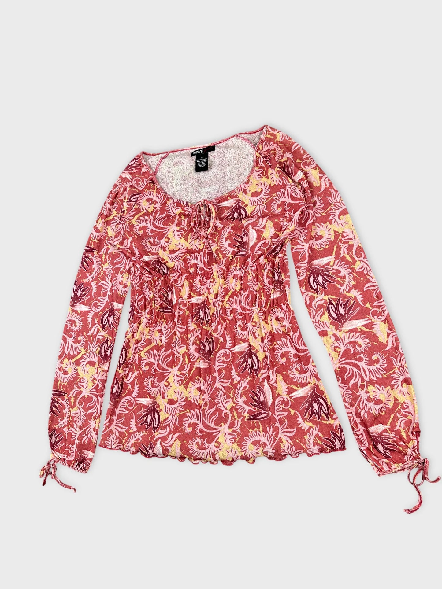 Detail view of a vintage women body shirt in red floral pattern.