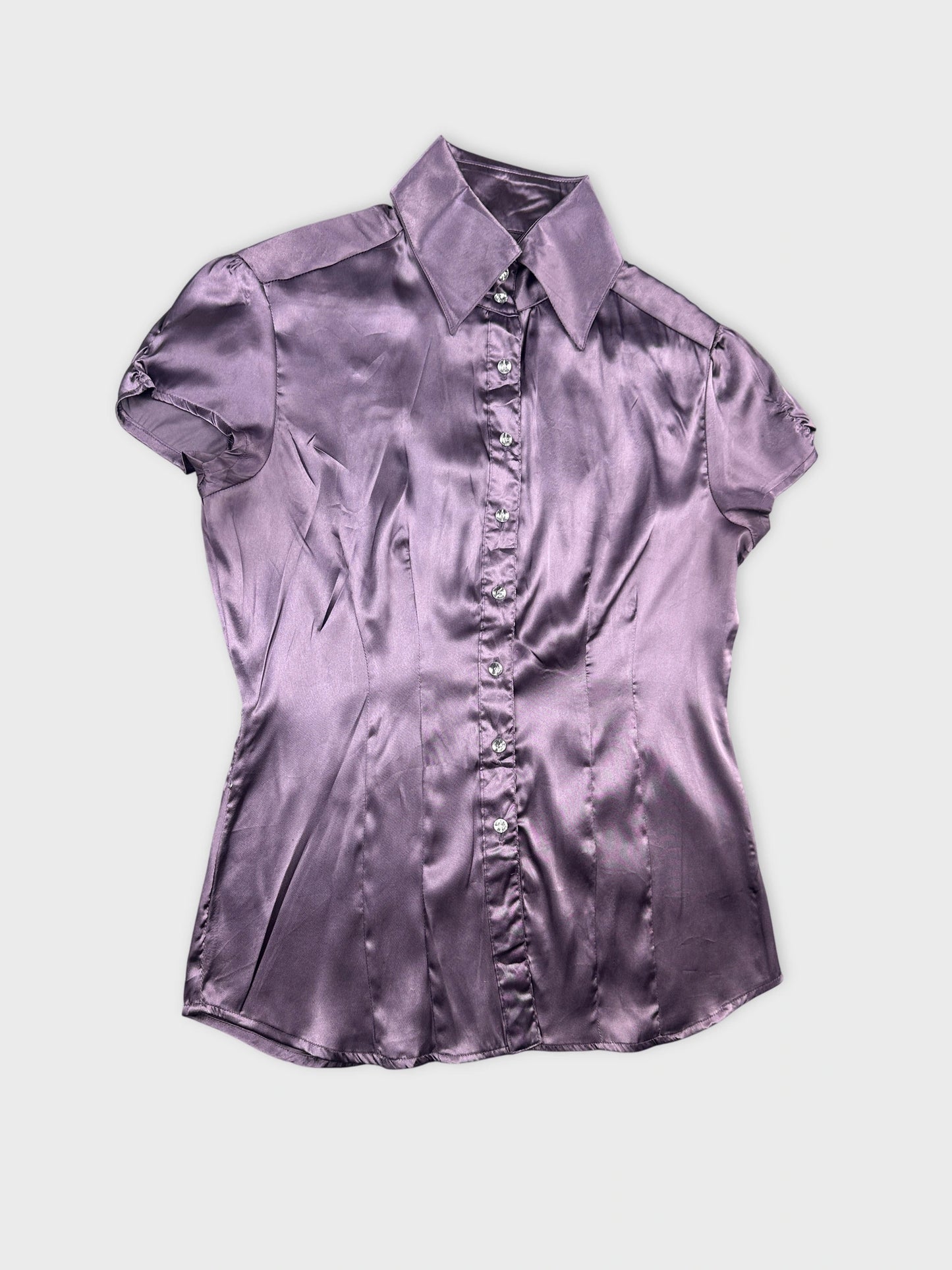 Detail view of a purple vintage body shirt with short sleeves and button front.