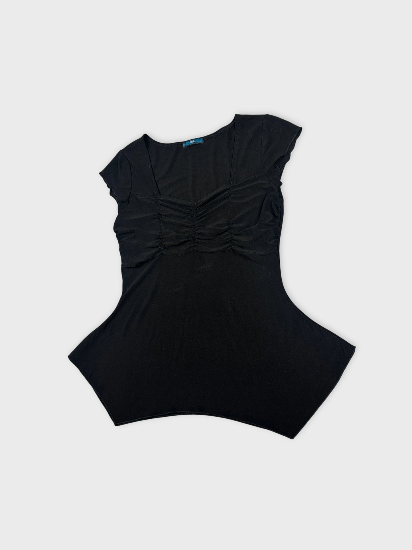 Detail view of a black body shirt with gathered front detail.