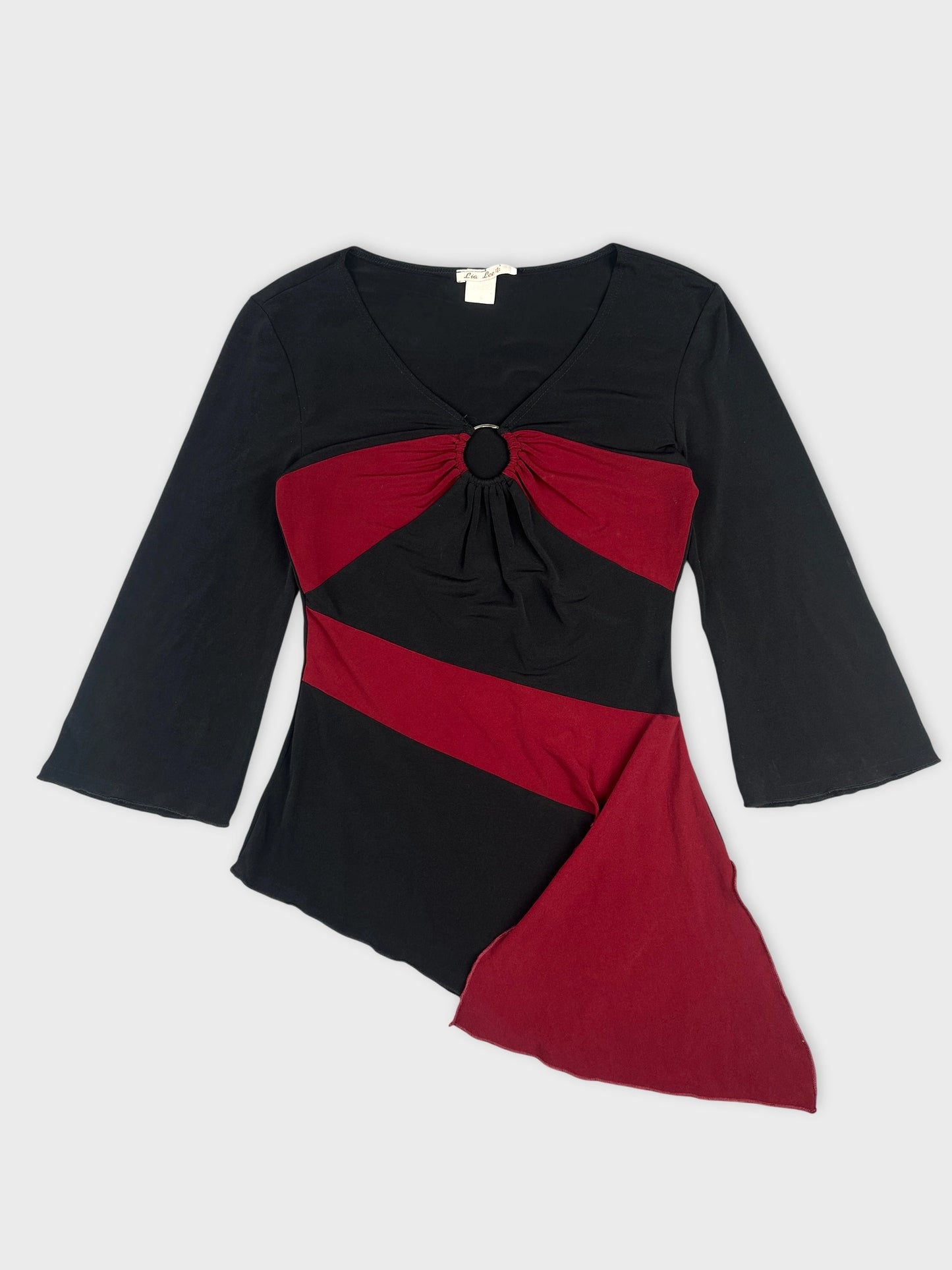 Front view of a women's body shirt in black and burgundy with a circular detail.