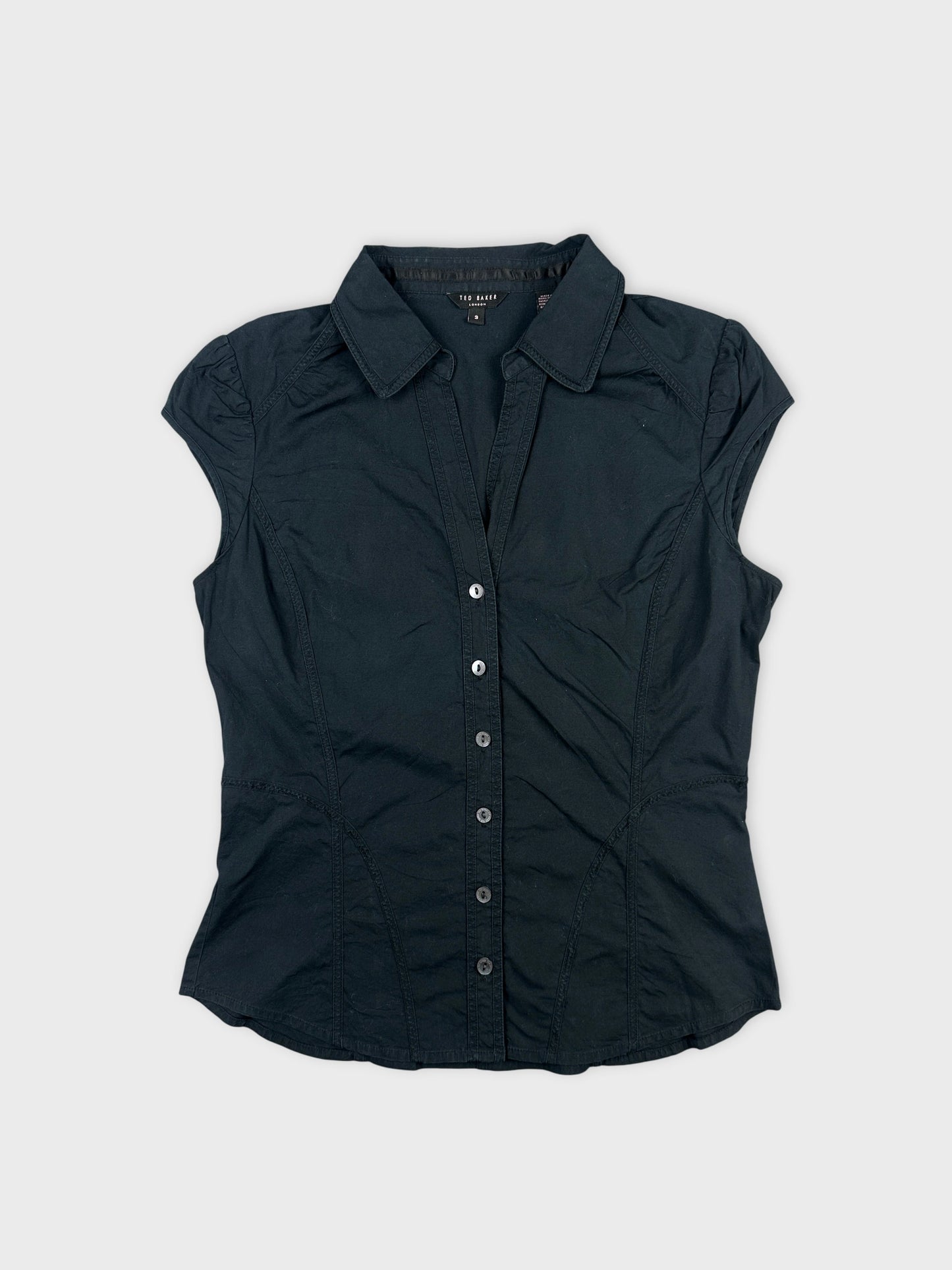 Black body shirt with fitted shape and button front view.