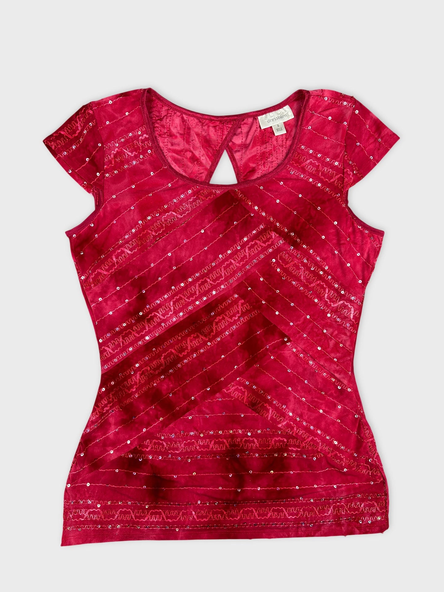 Front view of a pink body shirt with a keyhole detail and sequined pattern.