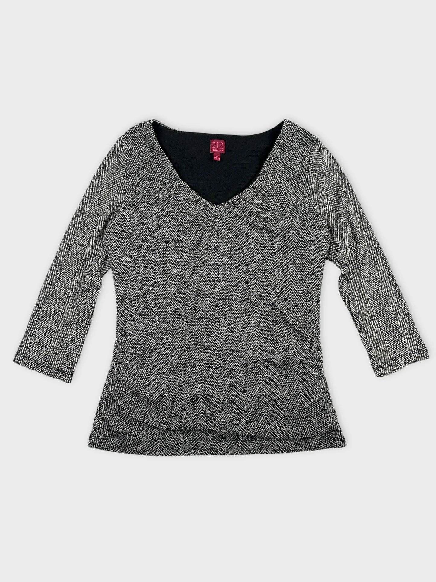 Front view of a black and white patterned body shirt with a v-neck.