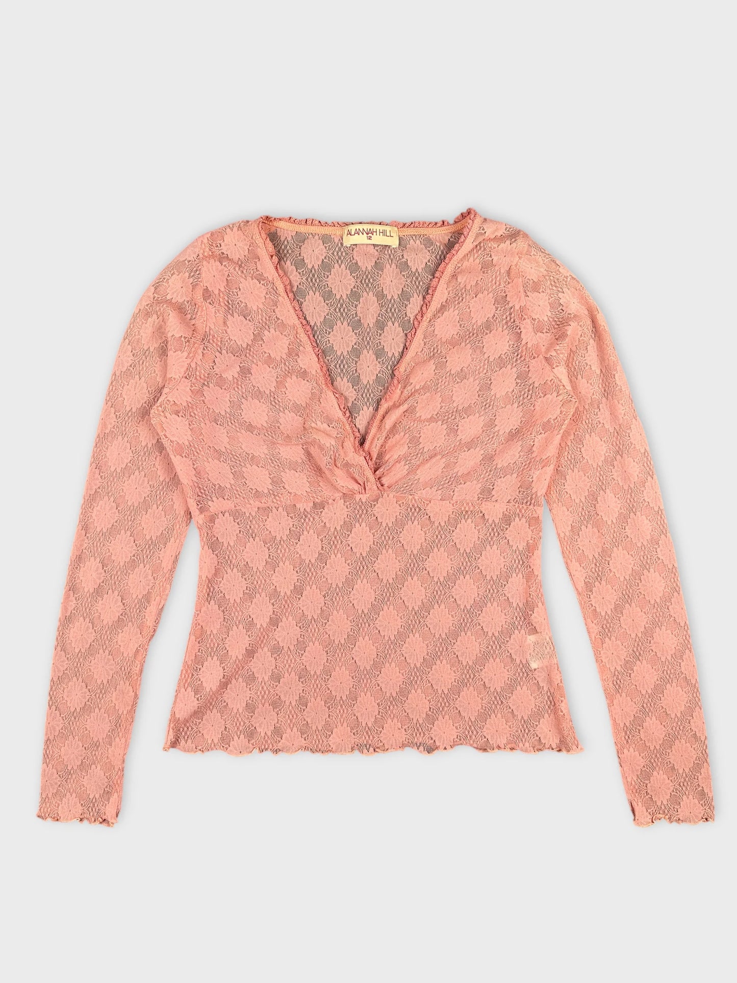 Front view of a pink lace body shirt with a v-neck and scalloped hem.