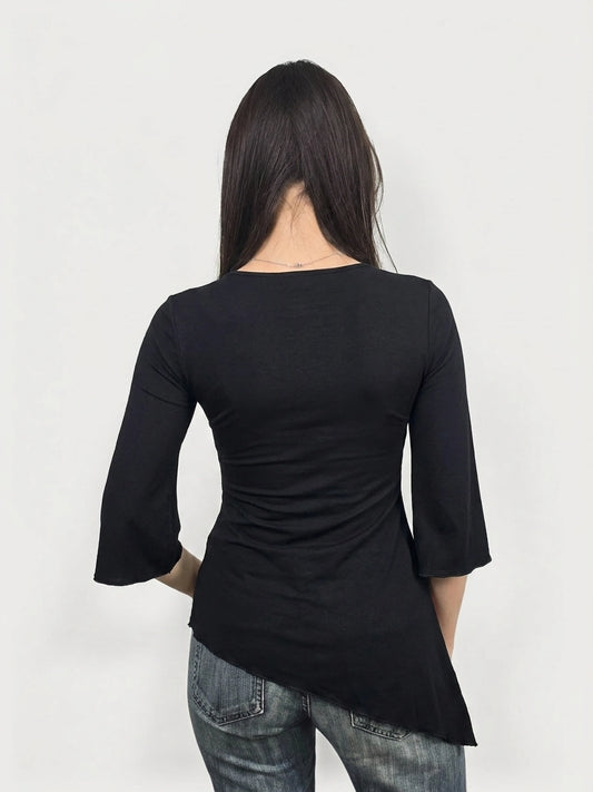 Back view of a black body shirt featuring a asymmetrical hem.