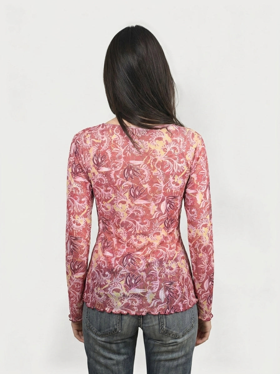 Back view of a pink floral body shirt with long sleeves.