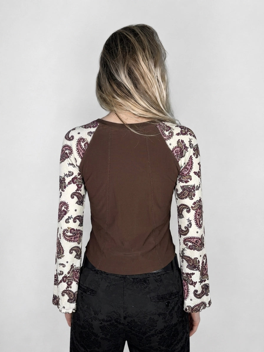 Back view of a brown body shirt with paisley-print sleeves.