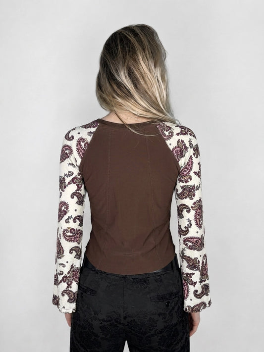Back view of a brown body shirt with paisley-print sleeves.