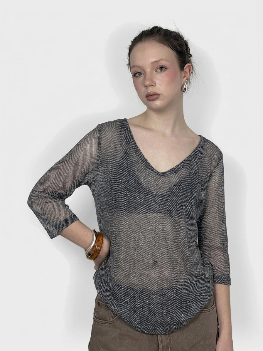 Front view of a women's body shirt in black with a herringbone pattern.