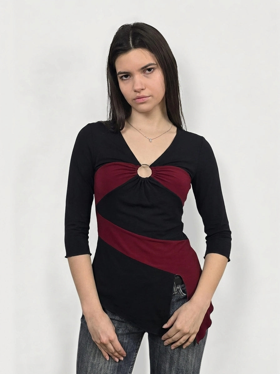 Front view of a black and burgundy body shirt featuring a circular detail.