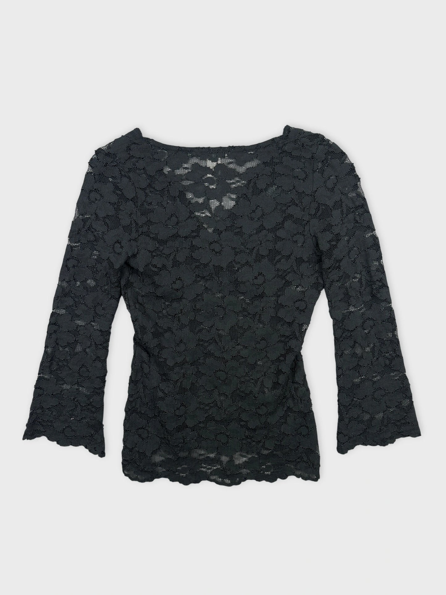 Back view of a black lace body shirt with floral pattern.
