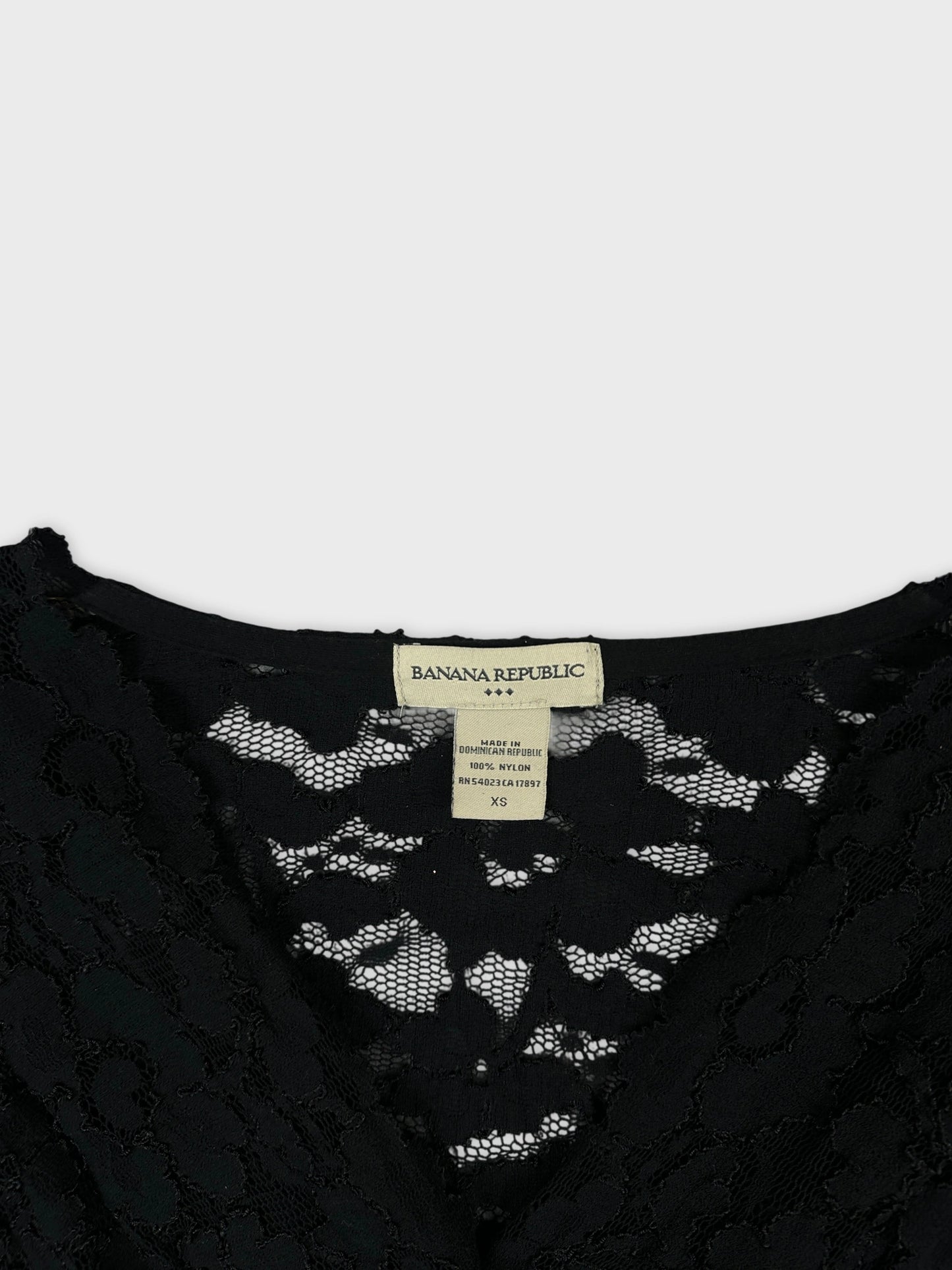 Black lace body shirt detail view featuring a V-neck design.