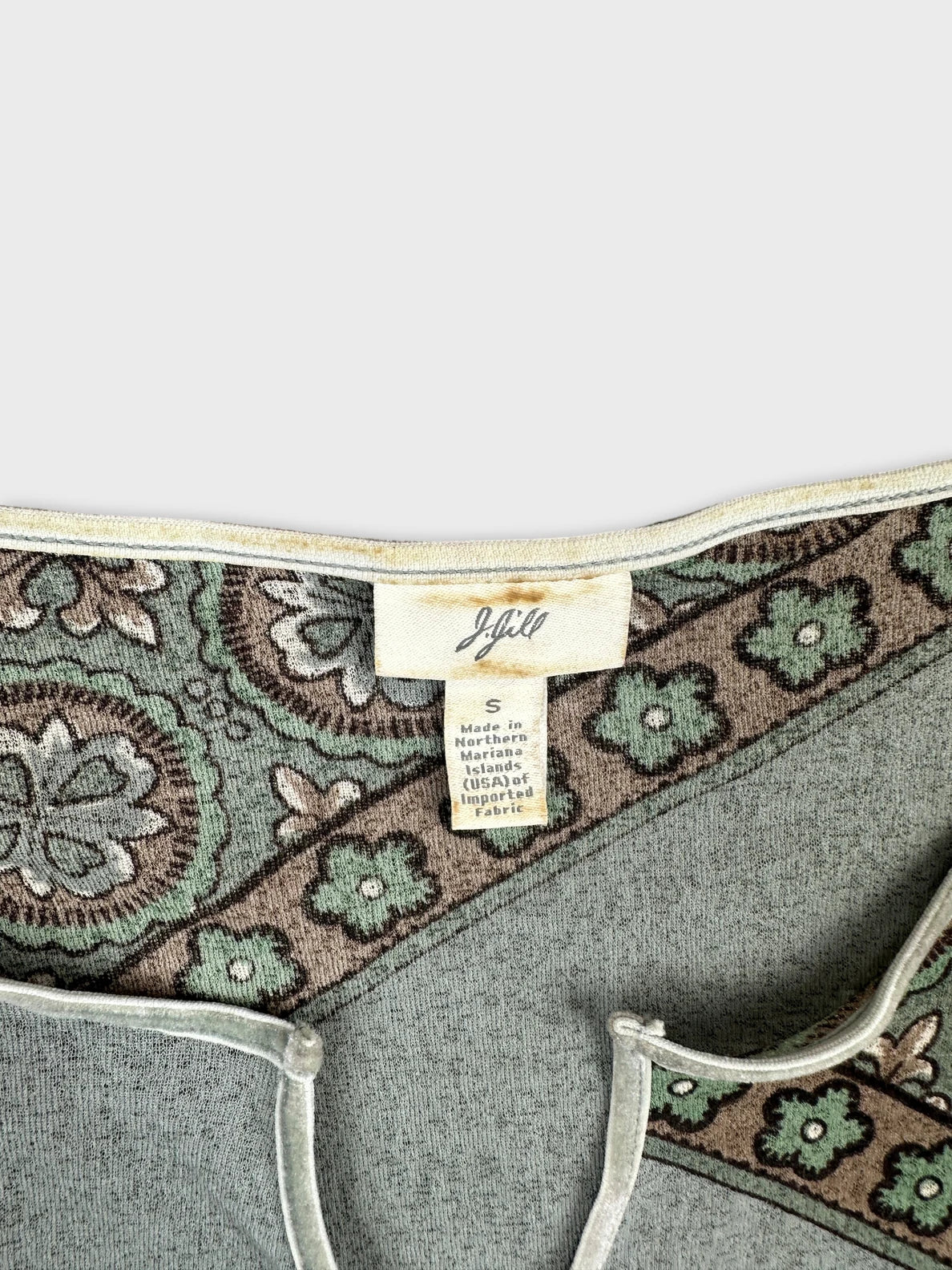 detail view of a vintage body shirt in green with floral print