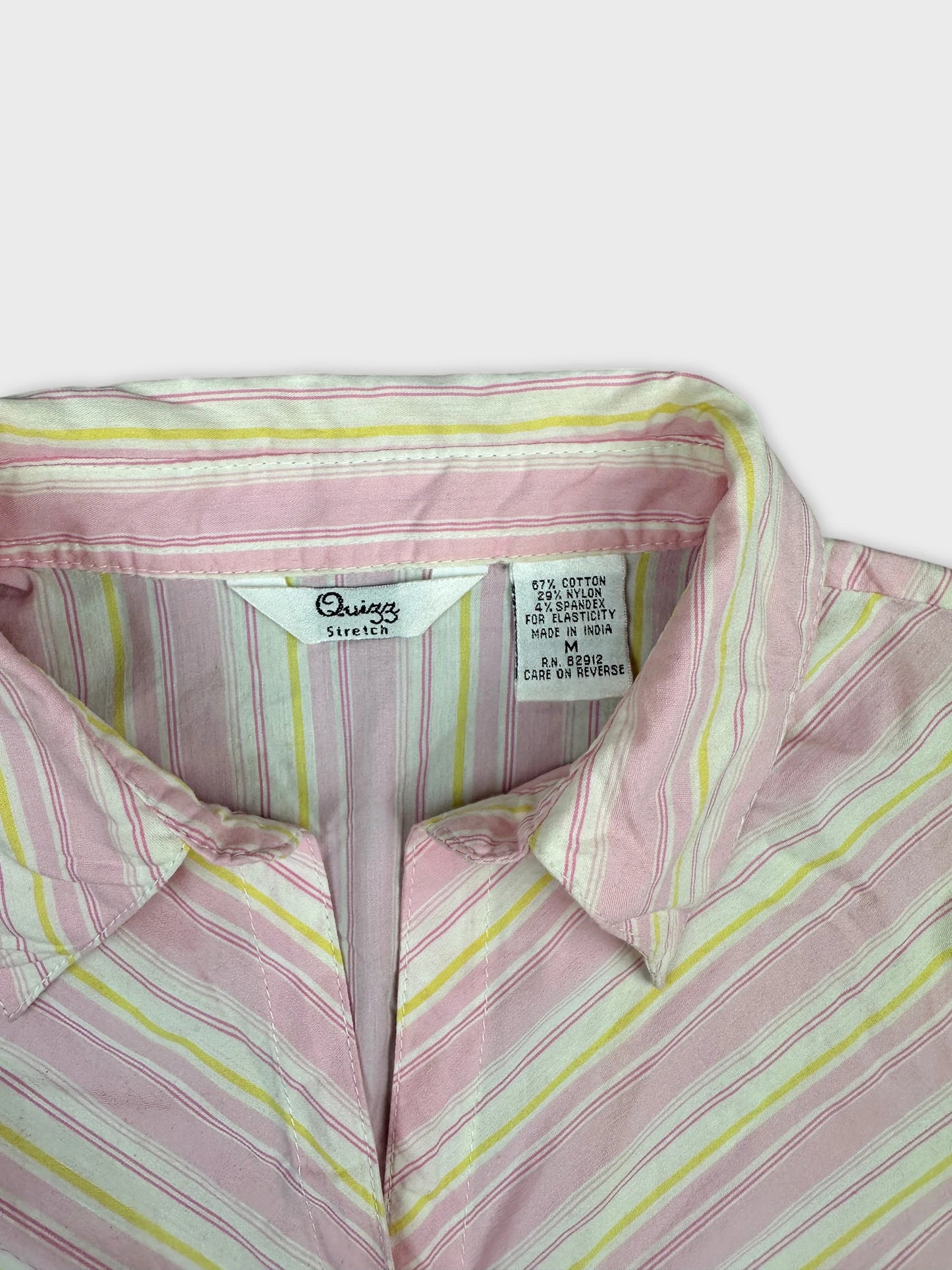 detail view of a pink and white striped women’s body shirt collar